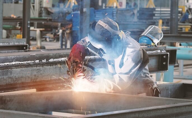 Welding application taking place in an enclosed facility.