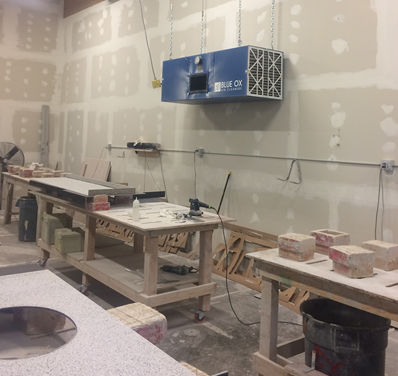 Wall-mounted Blue Ox air filtration unit installed in an industrial silica dust environment.
