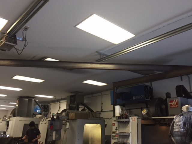 OX3500C ambient air cleaner removing welding fog and metal particulate in industrial machine shop.