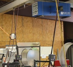 OX3500C air cleaner with T-Style airflow pattern and silencer in industrial machining facility.