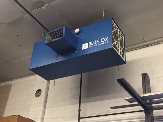 Blue Ox OX3500C air filtration unit with dual micro-glass fiber filters mounted on shop ceiling.