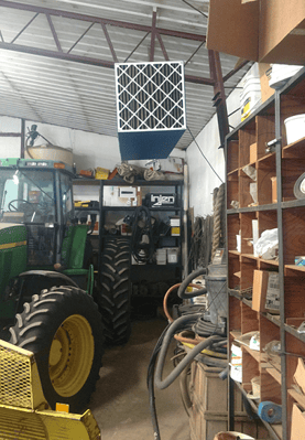 OX3000 ambient air cleaner creating continuous air circulation to prevent welding fume accumulation in small shop.