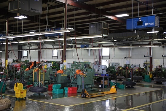 OX3500C ambient air cleaner installed above cold-header machines at Mac Fasteners to capture heavy oil mist at the source.