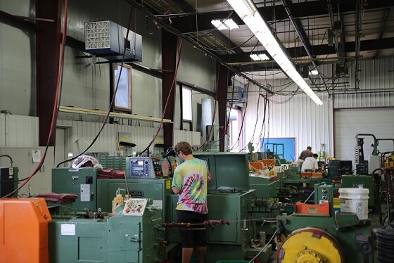 T-style airflow pattern of the OX3500C air cleaner pulling oil mist through dual side inlets and releasing filtered air.