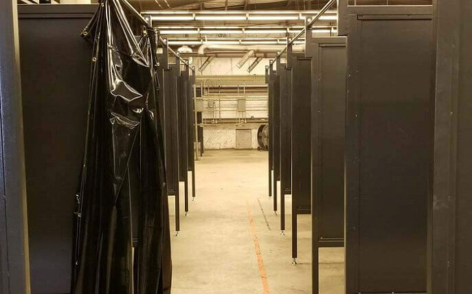 Welding booths shown in a high school weld shop.