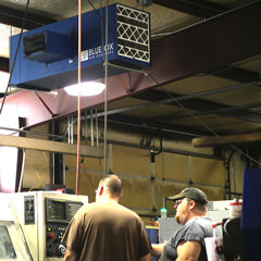 OX3500C ambient air cleaner removing black particulate from a machine shop with CNC and welding equipment