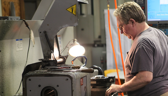 Ambient air filtration system controlling black oxide and metal dust in machine shop.